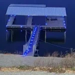 Covered multi slip dock with blue lit stairs at Grand Lake in Oklahoma
